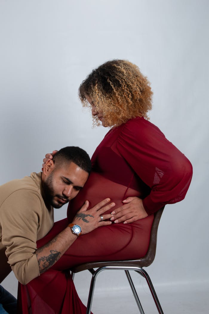 An intimate moment between a couple celebrating pregnancy, with love and anticipation.